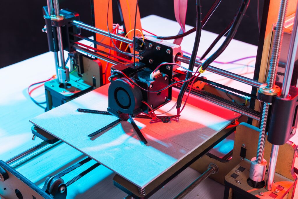 3d printer working and printing plastic prototype